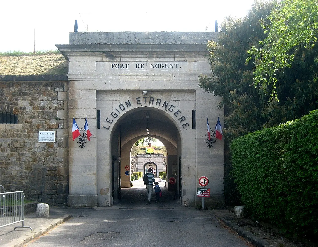 Entrance to Fort de Nogent, with Légion étrangère lettering above the gate and French flags